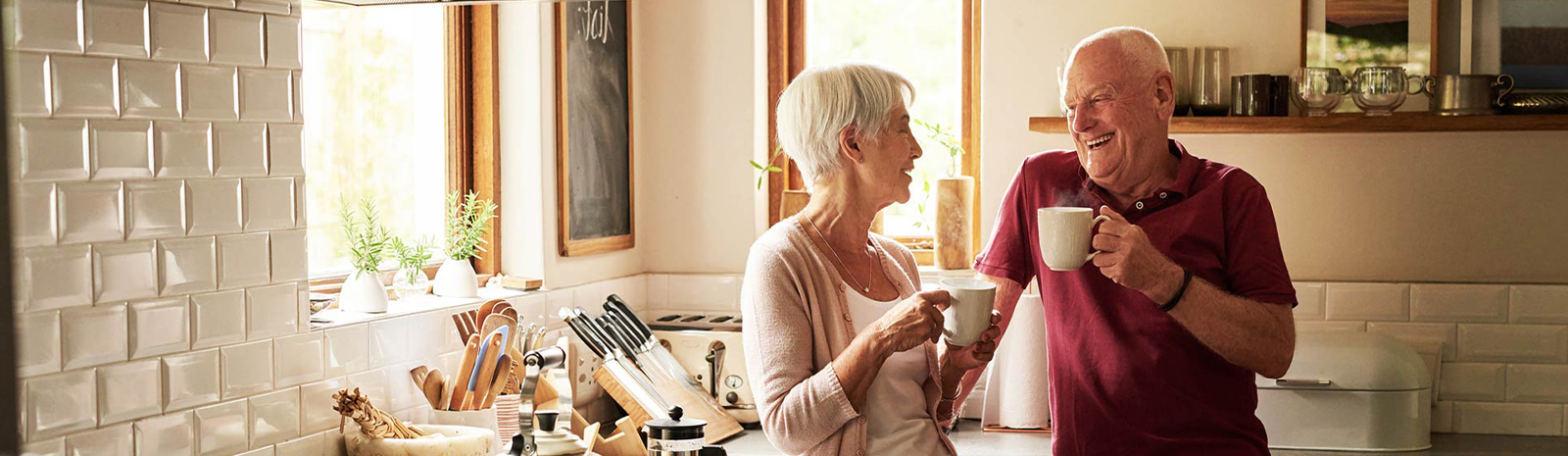 Couple in their kitchen drinking coffee.